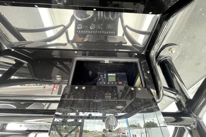 Slide: The Image of 2019 ShearWater 25 LTZ boat dashboard with Simrad electronics and black finish. - 56