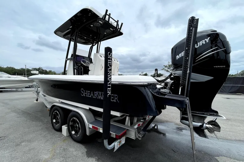 Slide: The Image of 2019 ShearWater 25 LTZ boat with Mercury Verado engine on a trailer. - 7
