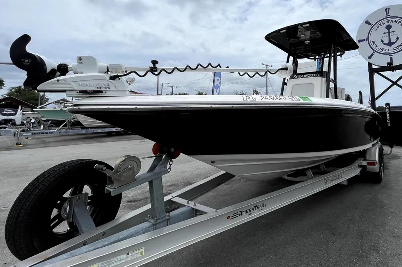 Slide: The Image of 2019 ShearWater 25 LTZ boat on trailer under cloudy sky at a dealership. - 9