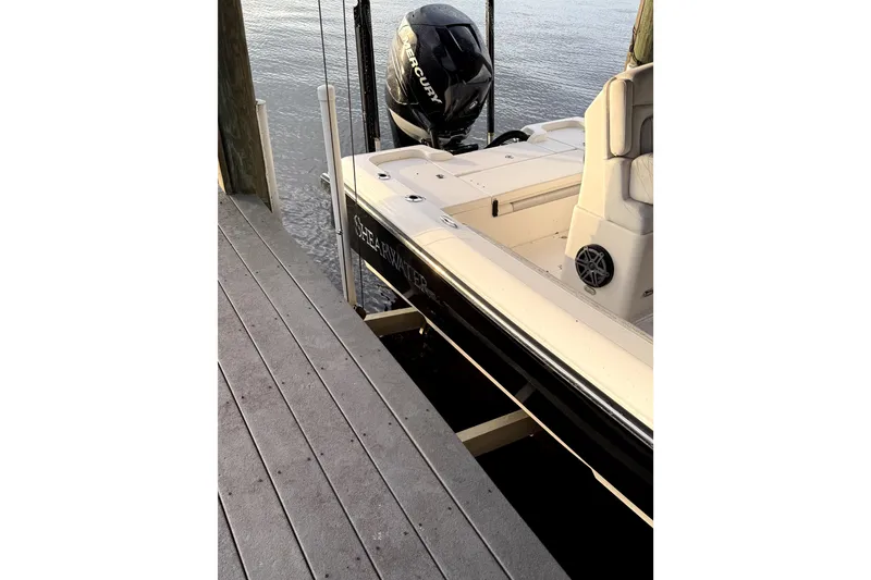 Slide: The Image of 2019 ShearWater 25 LTZ boat docked, featuring a Mercury outboard motor. - 4