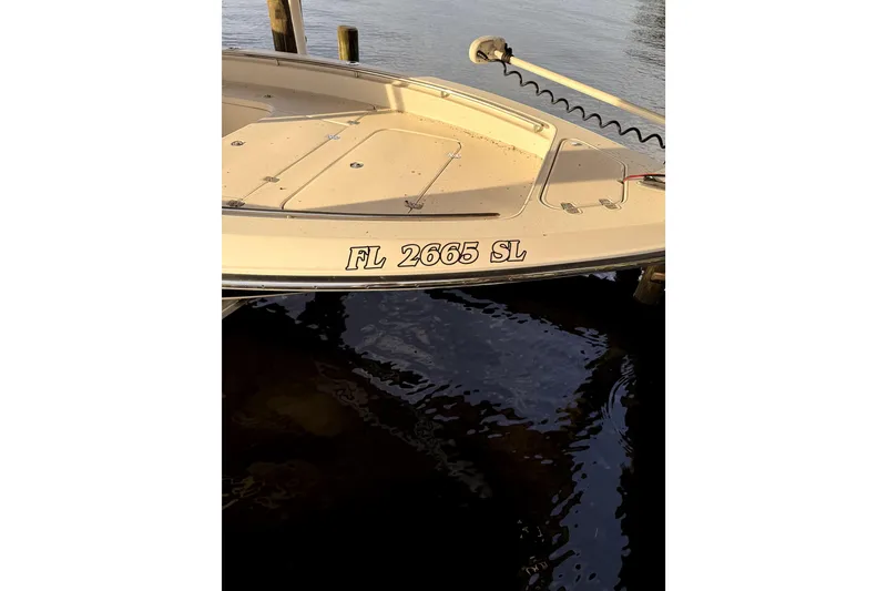 Slide: The Image of 2019 ShearWater 25 LTZ boat docked, displaying registration number FL 2665 SL. - 5