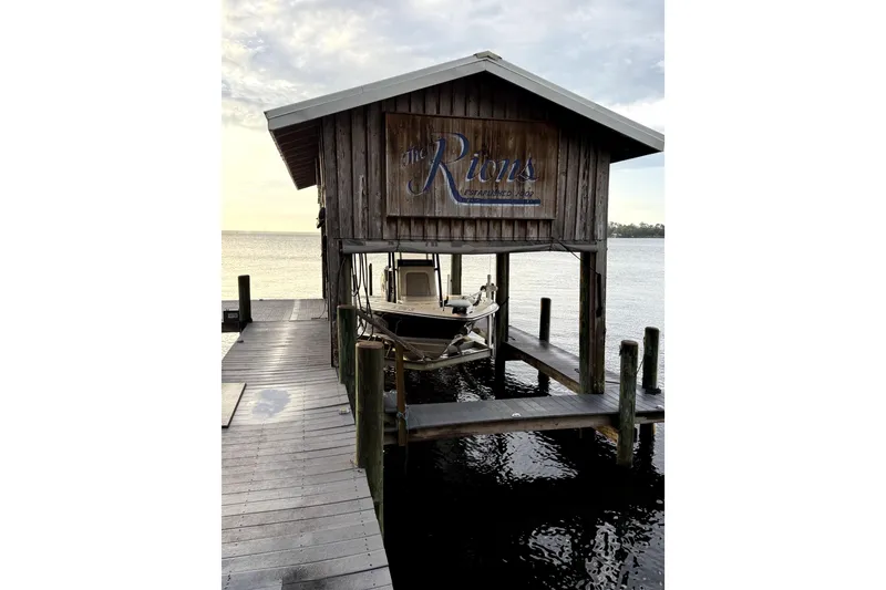 Slide: The Image of Boat docked in a wooden boathouse on a serene waterfront, ShearWater 25 LTZ, 2019. - 6
