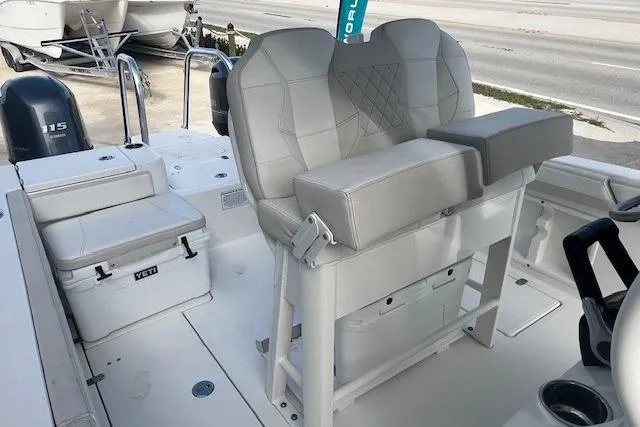 Slide: The Image of 2025 World Cat 235 TE boat interior with cushioned seating and Yeti cooler. - 5