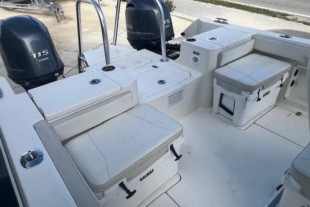 Slide: The Image of 2025 World Cat 235 TE boat interior with seating and dual 115 engines. - 6