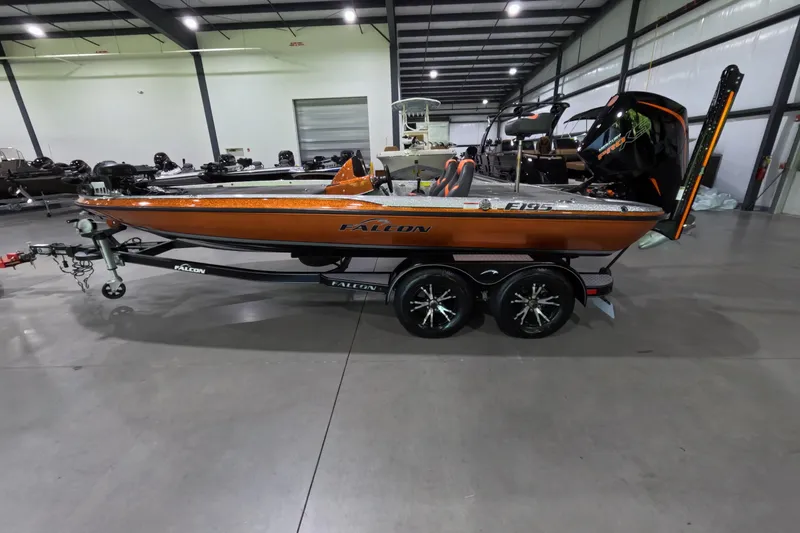 The Image of 2021 Falcon Boats 195 in showroom, orange finish, on trailer, side view. - 1