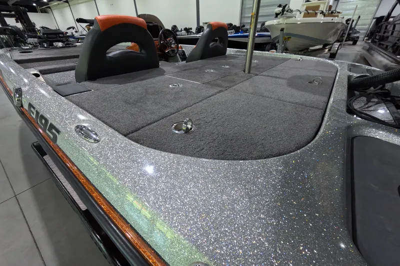 Slide: The Image of 2021 Falcon Boats 195 with glitter finish, showcasing spacious deck and seating in showroom. - 11