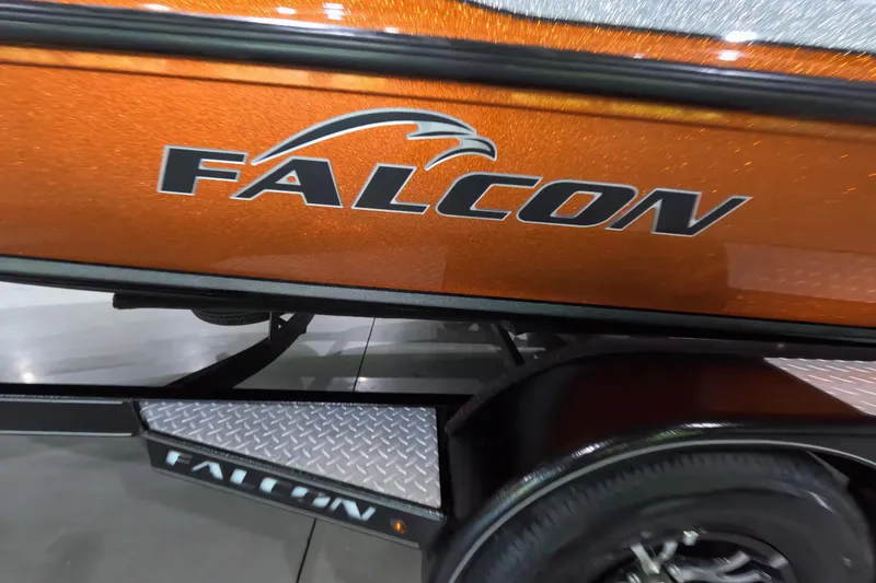 Slide: The Image of 2021 Falcon Boats 195, orange exterior with logo, displayed on trailer. - 16