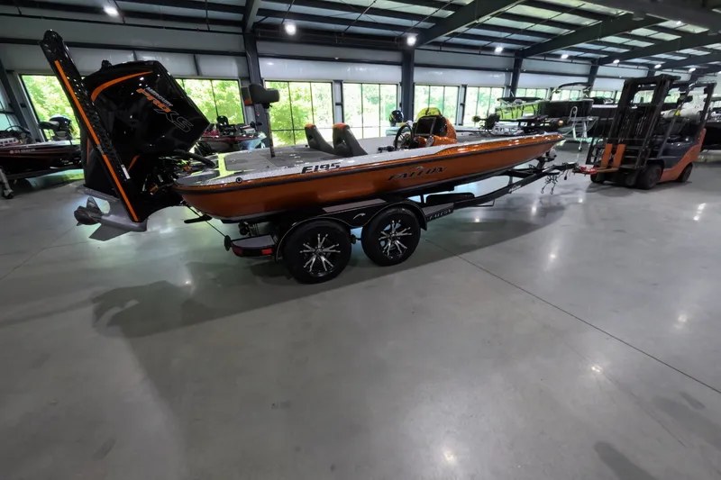 Slide: The Image of 2021 Falcon Boats 195 in showroom, orange hull, on trailer, with outboard motor. - 5