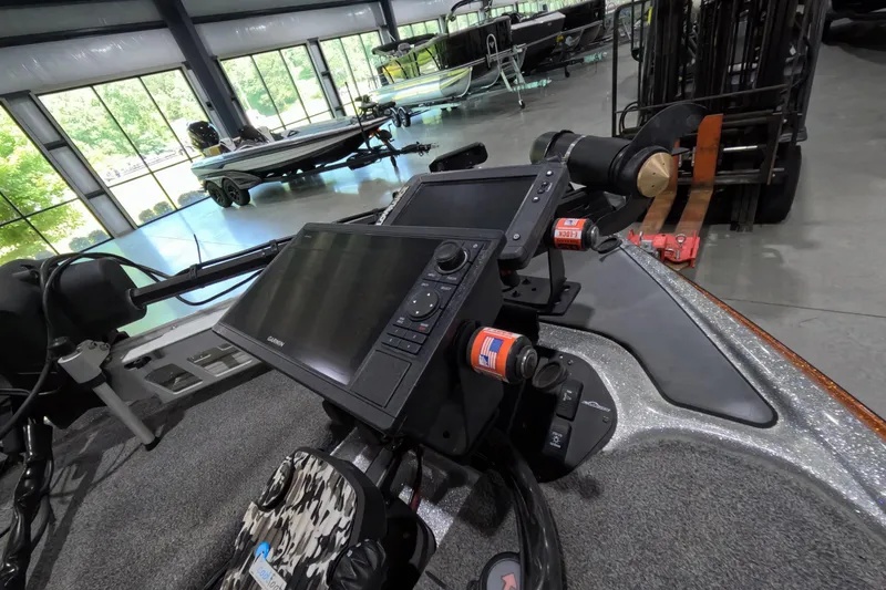 Slide: The Image of 2021 Falcon Boats 195 dashboard with advanced navigation systems in a showroom setting. - 7