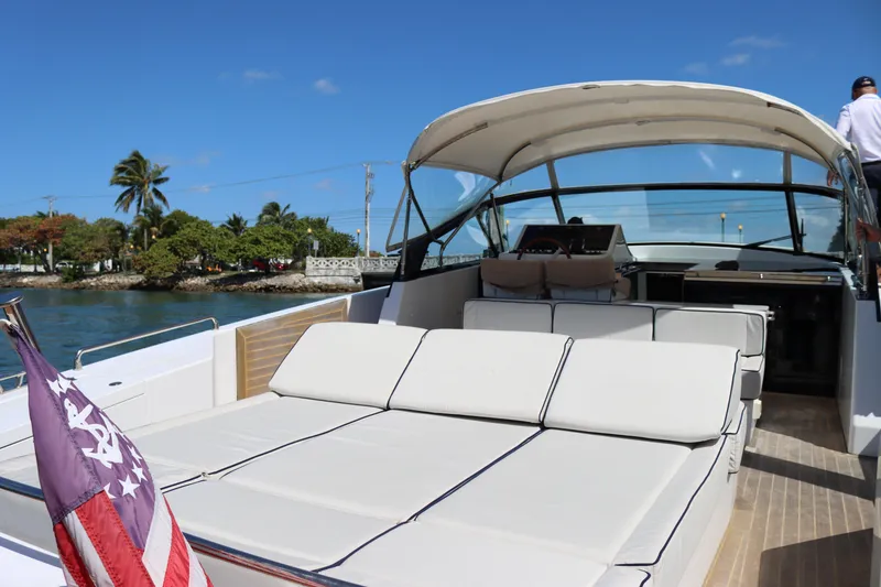 Slide: The Image of Luxurious 2010 CNM 50 yacht with spacious deck, docked near tropical shoreline. - 11