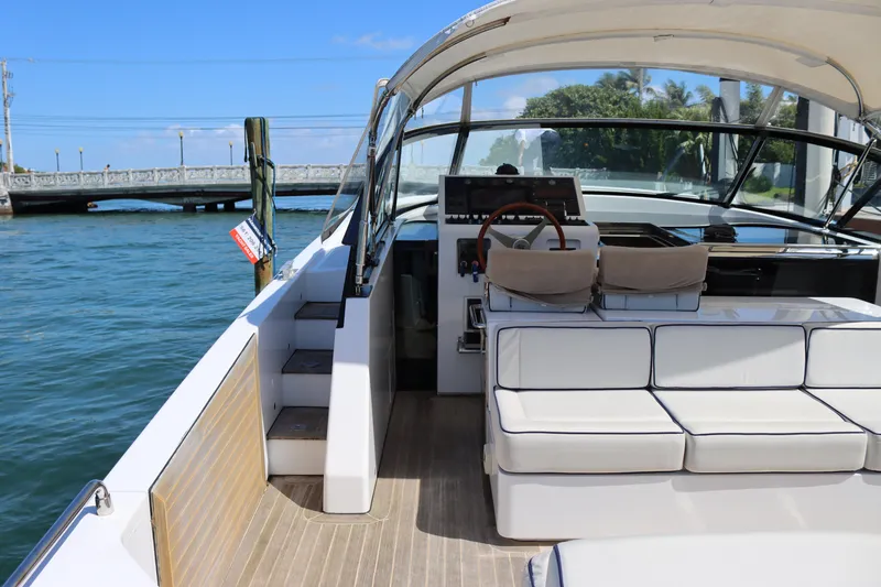 Slide: The Image of Luxury CNM 50 yacht interior with helm, seating, and waterfront view, 2010 model. - 13