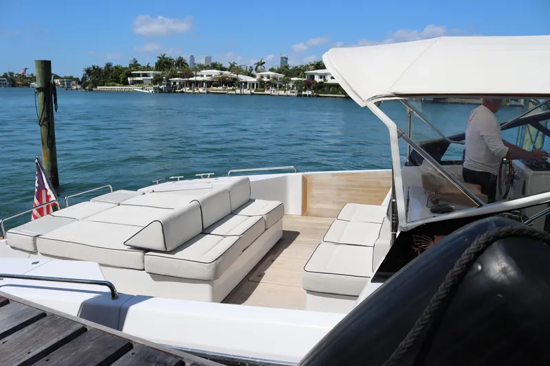 Slide: The Image of Luxurious CNM 50 yacht from 2010 docked by serene waterfront with plush seating. - 25