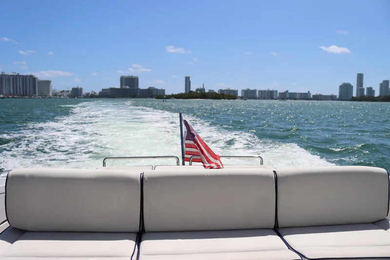 Slide: The Image of Luxury yacht CNM 50 cruising with city skyline and American flag, 2010 model. - 27