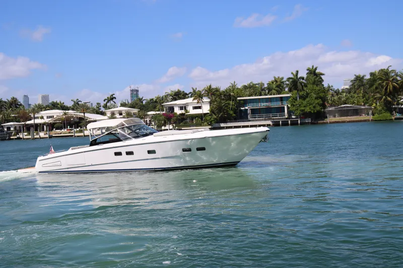 Slide: The Image of Luxury CNM 50 yacht cruising on a sunny day, 2010 model, near waterfront homes. - 4