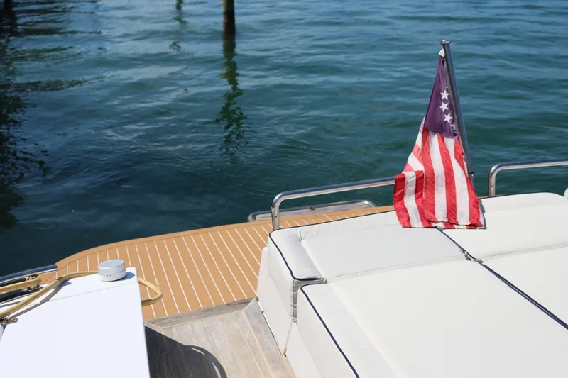 Slide: The Image of Rear deck of a 2010 CNM 50 yacht with American flag, overlooking water. - 9