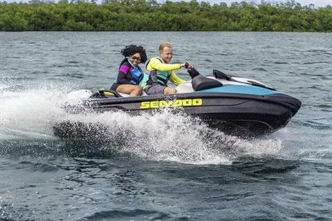 Slide: The Image of 2025 Sea-Doo GTI SE 130 jet ski with two riders enjoying a water adventure. - 8