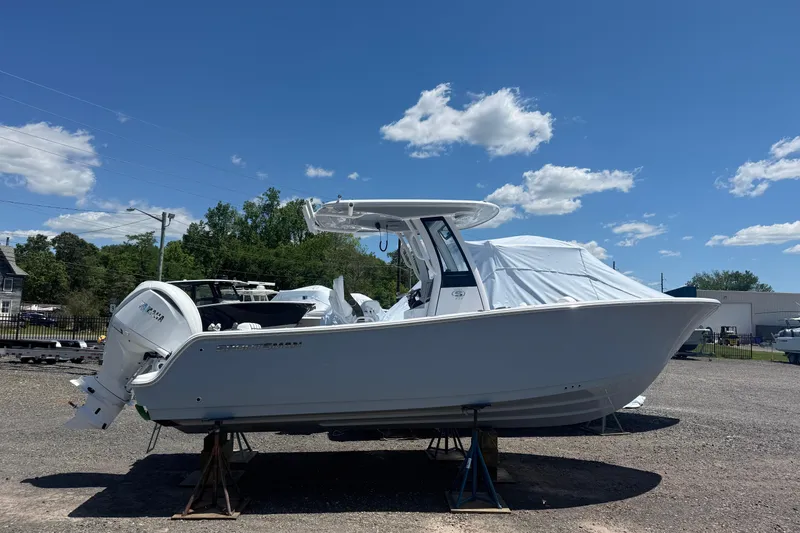 The Image of 2026 Sportsman Open 232 Center Console boat on display under a clear blue sky. - 0