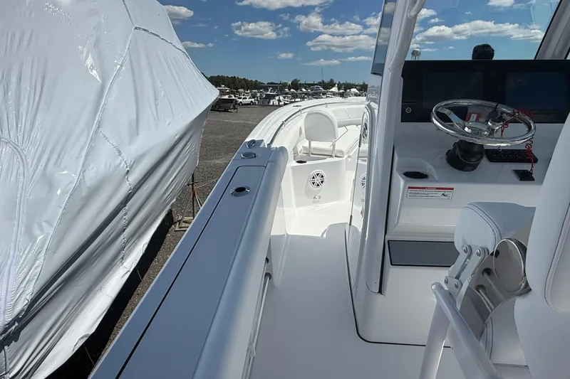 Slide: The Image of 2026 Sportsman Open 232 Center Console boat interior with steering wheel and seating. - 10