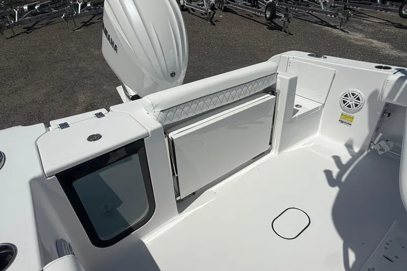 Slide: The Image of 2026 Sportsman Open 232 Center Console boat interior with Yamaha engine, featuring seating and storage. - 12