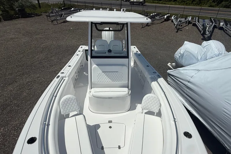 Slide: The Image of 2026 Sportsman Open 232 Center Console boat with sleek white seating and modern design. - 3