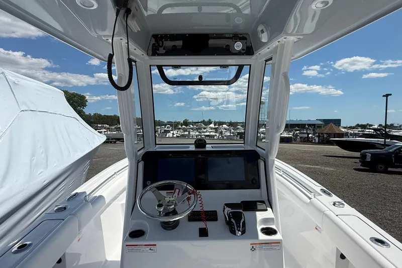 Slide: The Image of 2026 Sportsman Open 232 Center Console boat interior with steering wheel and controls. - 7