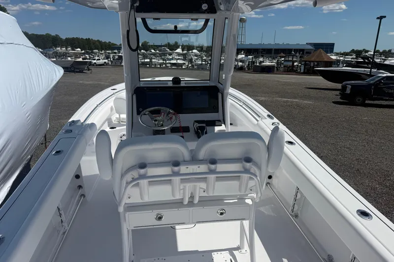 Slide: The Image of 2026 Sportsman Open 232 Center Console boat interior at marina, showcasing helm and seating. - 9