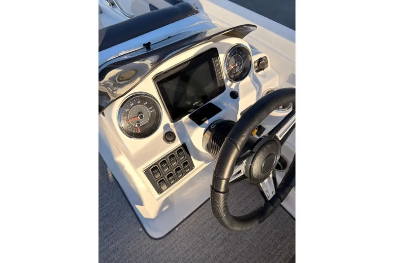 Slide: The Image of Dashboard of 2022 Hurricane SunDeck Sport 205 OB boat with steering wheel and gauges. - 12