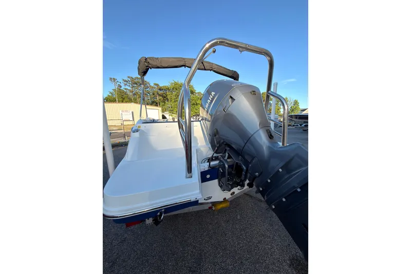 Slide: The Image of 2022 Hurricane SunDeck Sport 205 OB boat with Yamaha outboard motor, parked outdoors. - 15