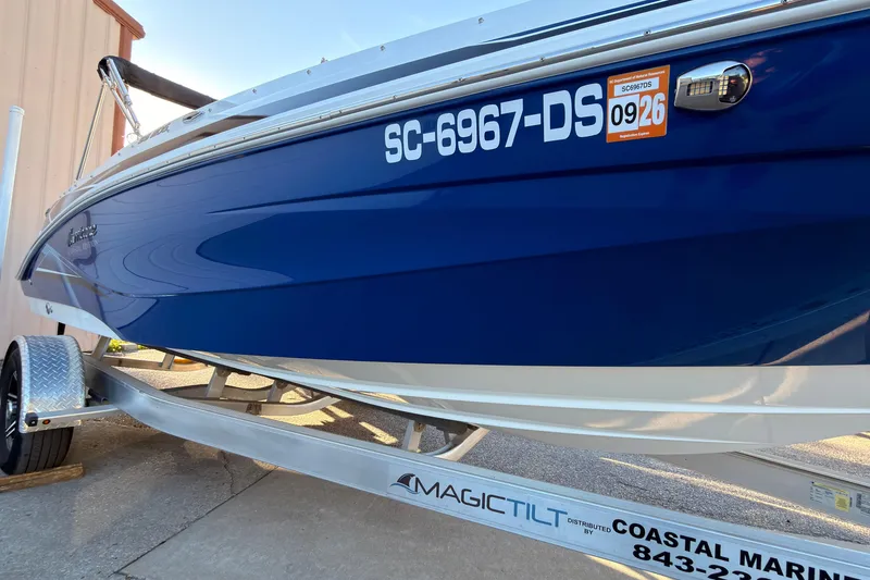 Slide: The Image of 2022 Hurricane SunDeck Sport 205 OB boat on trailer, blue hull, registration SC-6967-DS. - 2