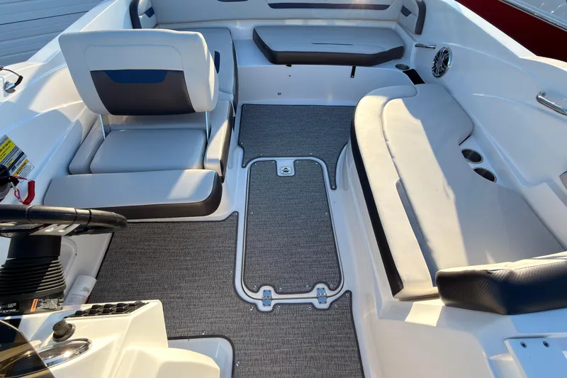Slide: The Image of Interior of 2022 Hurricane SunDeck Sport 205 OB boat with seating and steering wheel. - 6