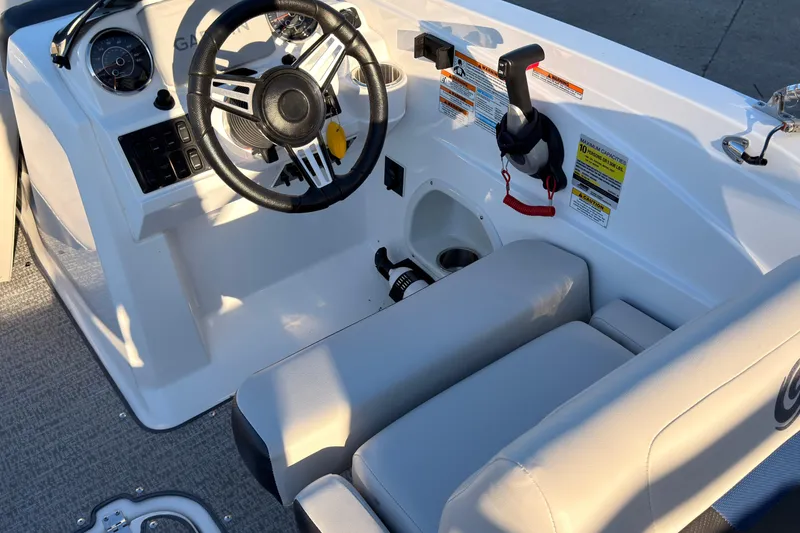 Slide: The Image of 2022 Hurricane SunDeck Sport 205 OB boat interior with steering wheel and controls. - 7