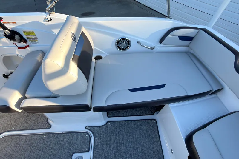 Slide: The Image of Interior seating of 2022 Hurricane SunDeck Sport 205 OB boat, featuring cushioned seats and speaker. - 9
