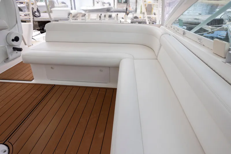Slide: The Image of White seating area on 2000 Cabo 45 Express boat with wooden flooring. - 7