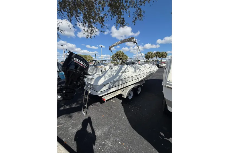 The Image of 2017 Hurricane SunDeck Sport CC 231 OB boat with Suzuki outboard motor on trailer. - 0