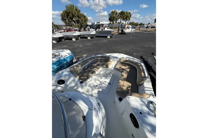 Slide: The Image of 2017 Hurricane SunDeck Sport CC 231 OB boat with spacious seating, parked outdoors. - 8