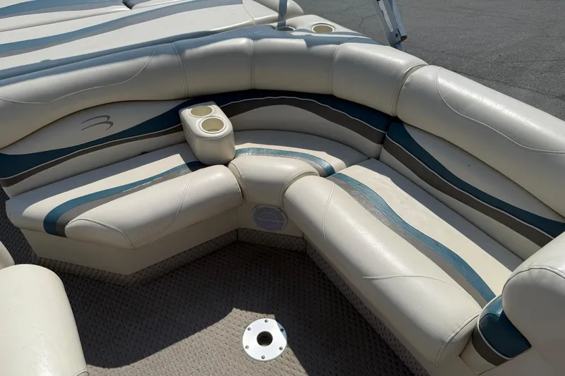 Slide: The Image of 2005 Bennington 2075RL boat interior with cushioned seating and cup holders. - 11