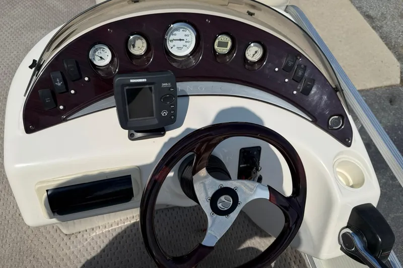 Slide: The Image of 2005 Bennington 2075RL boat dashboard with steering wheel and gauges. - 13