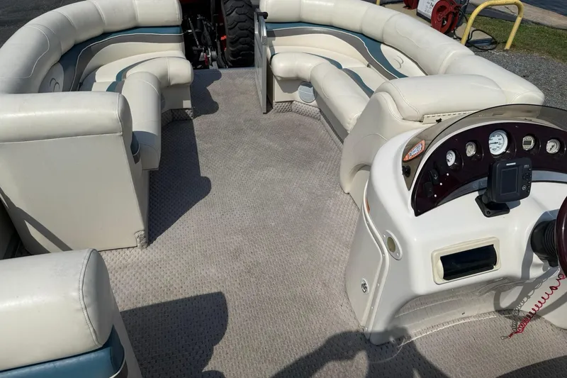 Slide: The Image of Interior of a 2005 Bennington 2075RL pontoon boat with plush seating and control panel. - 18