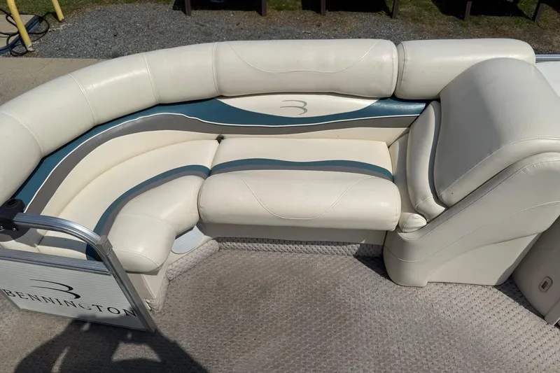 Slide: The Image of Bennington 2075RL 2005 boat interior with white and blue cushioned seating. - 9