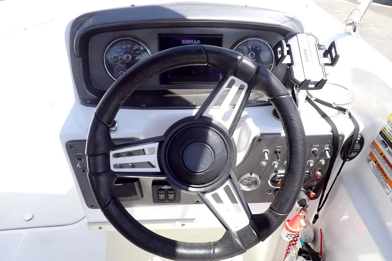 Slide: The Image of 2021 Hurricane SunDeck Sport 185 OB boat dashboard with steering wheel and controls. - 10