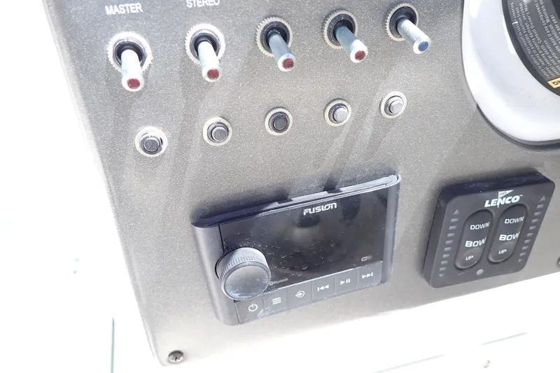 Slide: The Image of Control panel of 2021 Hurricane SunDeck Sport 185 OB with stereo and trim tab switches. - 14