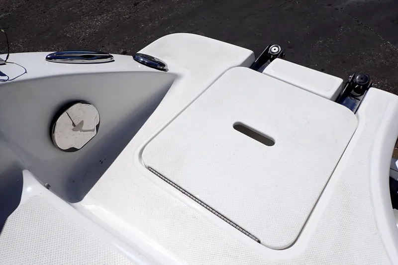 Slide: The Image of 2021 Hurricane SunDeck Sport 185 OB boat deck with storage compartment and chrome details. - 22