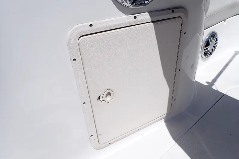 Slide: The Image of 2021 Hurricane SunDeck Sport 185 OB boat storage compartment with speaker detail. - 39