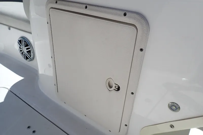 Slide: The Image of 2021 Hurricane SunDeck Sport 185 OB boat storage compartment and speaker detail. - 41