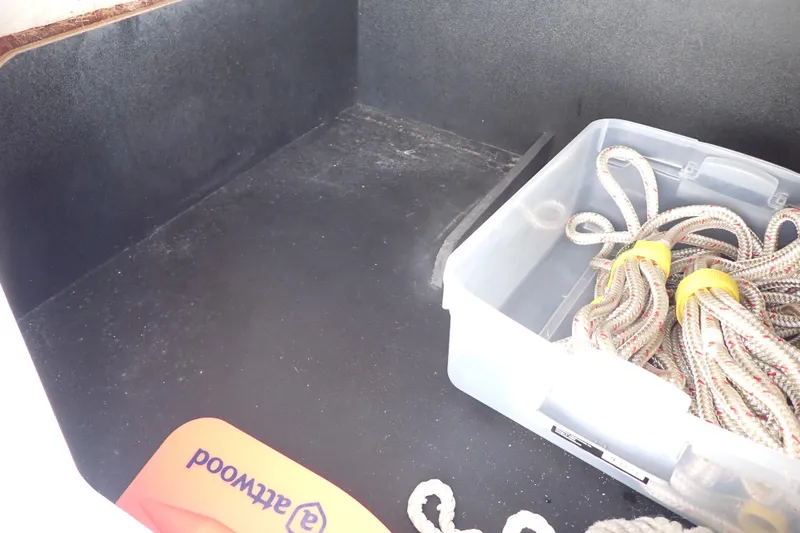 Slide: The Image of Storage compartment of 2021 Hurricane SunDeck Sport 185 OB with ropes and container. - 42