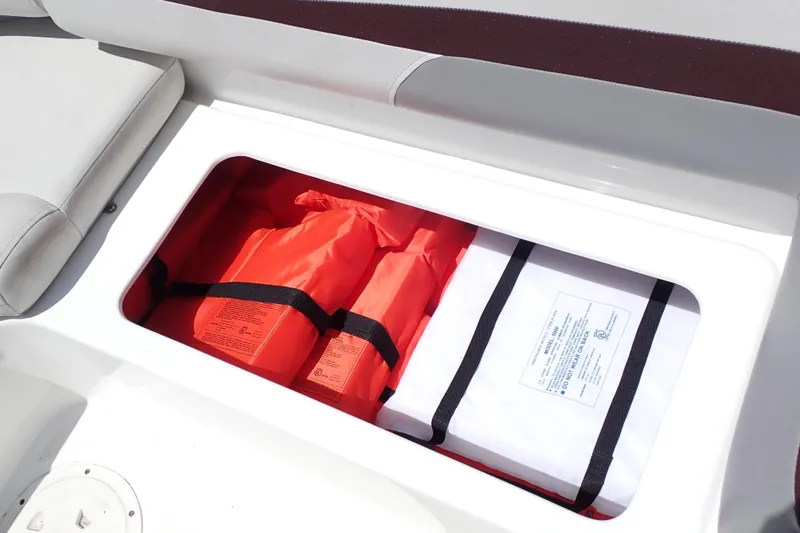 Slide: The Image of Storage compartment with life jackets on a 2021 Hurricane SunDeck Sport 185 OB boat. - 45