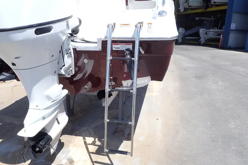 Slide: The Image of 2021 Hurricane SunDeck Sport 185 OB boat with ladder and outboard motor. - 49