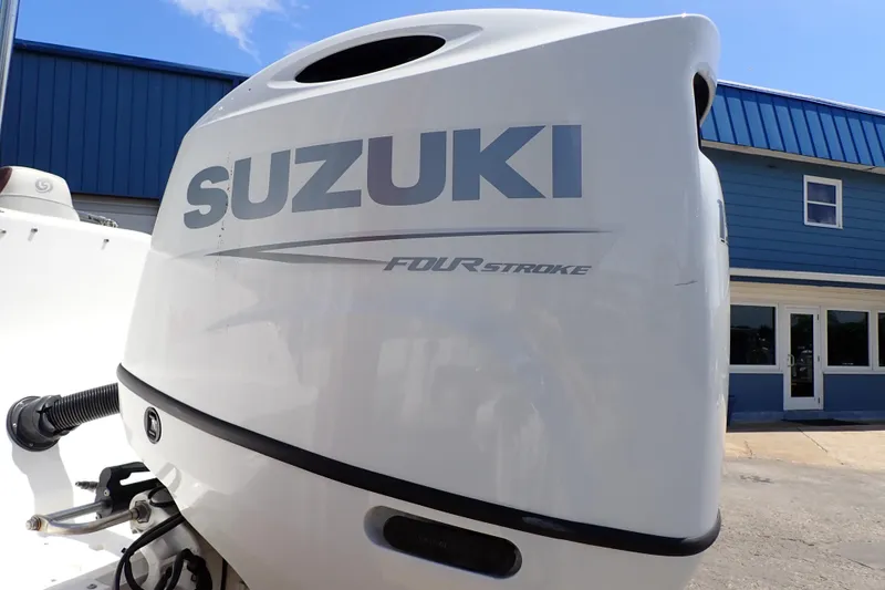 Slide: The Image of Suzuki Four Stroke engine on 2021 Hurricane SunDeck Sport 185 OB boat, outdoor setting. - 55