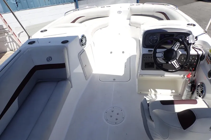 Slide: The Image of 2021 Hurricane SunDeck Sport 185 OB boat interior with steering console and seating. - 6