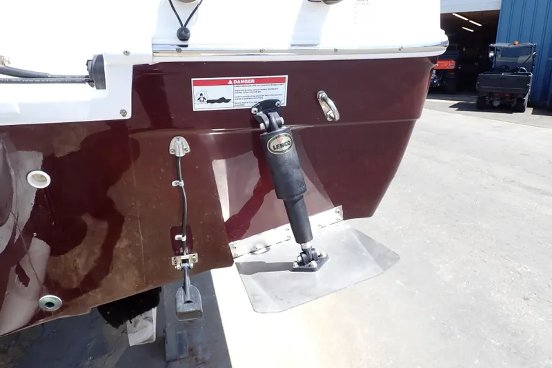 Slide: The Image of 2021 Hurricane SunDeck Sport 185 OB boat stern with trim tab and warning label. - 62